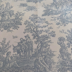 May include: A light beige fabric with a blue toile pattern. The design depicts pastoral scenes with figures, trees, and animals. The overall aesthetic is reminiscent of classic French country decor.