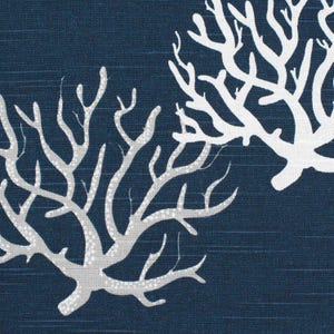 May include: A dark navy blue fabric featuring a repeating pattern of white coral branches. The textile has a subtle horizontal weave texture throughout, with the coral motifs displayed in a stark, high-contrast white against the deep blue background.