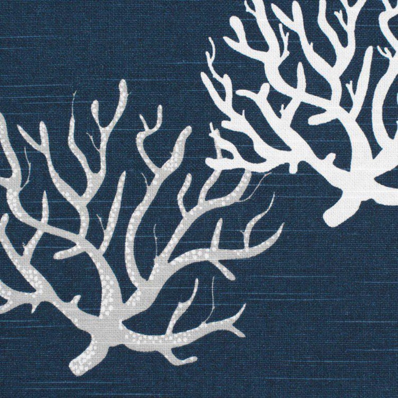 May include: A dark navy blue fabric featuring a repeating pattern of white coral branches. The textile has a subtle horizontal weave texture throughout, with the coral motifs displayed in a stark, high-contrast white against the deep blue background.