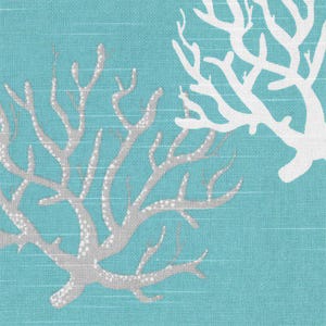 May include: A teal fabric featuring a repeating pattern of white and light gray coral silhouettes. The textile has a visible woven texture with horizontal lines, showcasing detailed branching structures of the coral motifs across the surface.