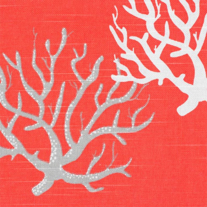 May include: A vibrant coral-colored fabric featuring a repeating pattern of branching coral structures. One coral motif is rendered in a light gray with a subtle dotted texture, while the other is a solid, opaque white, creating a high-contrast design.