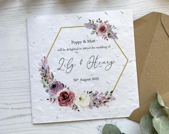 May include: A white wedding invitation with a gold hexagonal frame and floral design. The text reads "Poppy & Matt will be delighted to attend the wedding of Lily & Henry 26th August 2025."