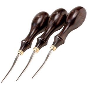 May include: Three leatherworking tools with dark brown wooden handles and curved, silver blades. The handles have a polished finish with a brass-coloured collar at the blade base. The tools are arranged in a row, angled slightly.