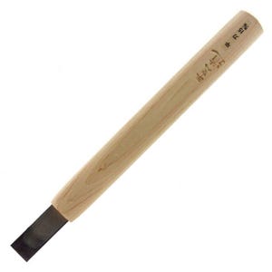 May include: A Japanese wood chisel with a light-colored wooden handle and a dark, rectangular blade. The handle has Japanese text printed on it. The chisel is designed for woodworking and carving.