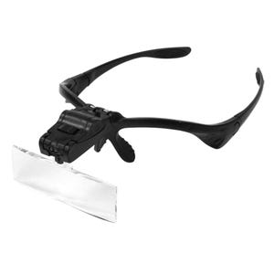 May include: Black magnifying glasses with a built-in LED light and a clear lens. The glasses have a flexible headband and a clip to hold them in place.