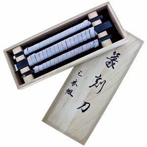 May include: A wooden box containing three wrapped tools. The tools have light gray wrapped handles and black blades. The box is open, revealing the contents, and the lid is partially open, displaying Japanese characters.