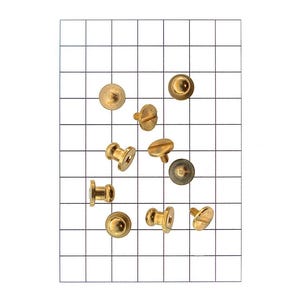 May include: A collection of brass-colored metal studs and fasteners, including button studs, screw studs, and decorative studs. The hardware is arranged on a grid background, showcasing various shapes and sizes. Ideal for craft projects or garment construction.