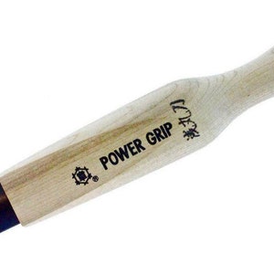 May include: A wooden tool with a black blade and a handle that says "POWER GRIP" and "1.5" in black lettering.
