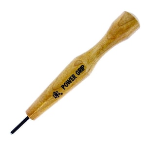 May include: A wooden tool with a black metal tip and a brown wooden handle. The handle has the text "POWER GRIP" printed on it.