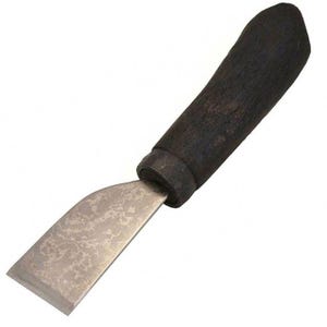 May include: A leather working tool with a black wooden handle and a flat, slightly curved blade. The blade has a textured, hammered finish.