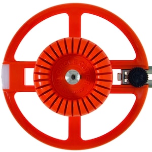 May include: An orange circle cutter tool with a central ridged wheel and a circular frame. The tool has a metal guide and a black adjustment knob. The text "CIRCLE CUTTER" is visible on the central wheel.