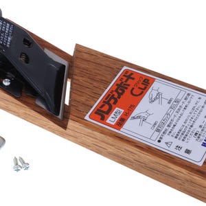 May include: A wooden hand tool with a black and silver blade and a black handle with a red accent. The tool has a label with Japanese text and comes with a small metal piece and screws.