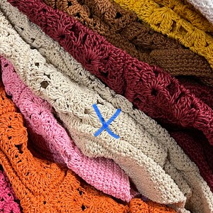 Puede incluir: Una pila de bolsos de crochet en varios colores, incluyendo verde, blanco, marr&oacute;n, amarillo, rojo, beige, rosa, naranja y rosa oscuro. Los bolsos est&aacute;n hechos con un patr&oacute;n delicado y de tejido abierto.