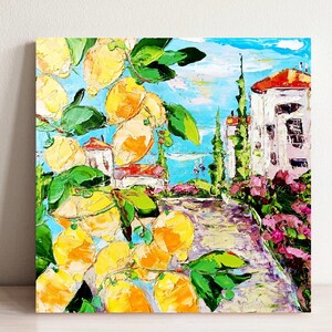 May include: A colorful oil painting depicting a lemon tree with ripe yellow lemons in front of a white building with a red roof. The building is surrounded by green trees and bushes, and the background is a blue sky with white clouds.