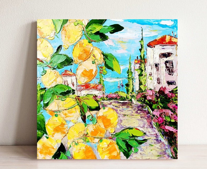 May include: A colorful oil painting depicting a lemon tree with ripe yellow lemons in front of a white building with a red roof. The building is surrounded by green trees and bushes, and the background is a blue sky with white clouds.
