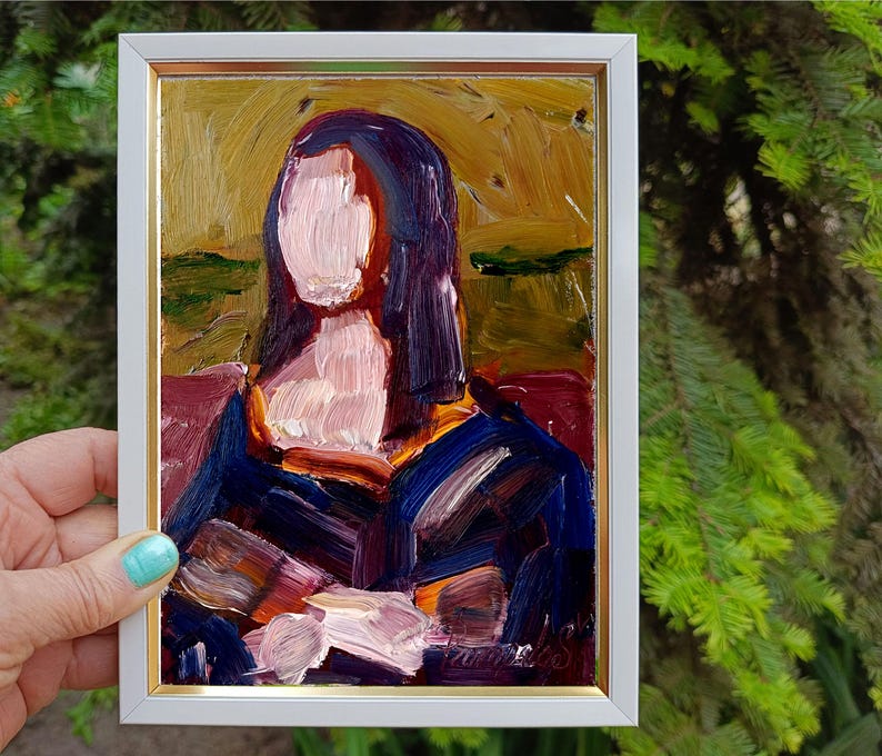 May include: Oil painting of a woman in a white framed gold-trimmed frame. The painting features a woman with dark hair and a blue dress. The painting has a textured brushstroke style with colors of blue, purple, and gold.