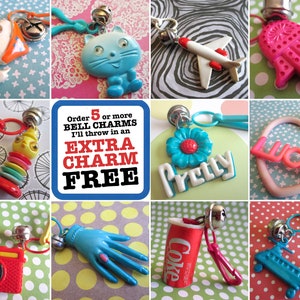 May include: A collage of colourful plastic charms with bells, including a cat, a flower, a plane, a hand, a heart, a camera, a glove, a coke can, and a helicopter. The text 'Order 5 or more BELL CHARMS I'll throw in an EXTRA CHARM FREE' is displayed in the centre of the collage.