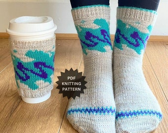 May include: A pair of grey knitted socks with a teal and purple abstract pattern. The socks are worn by a person wearing black leggings. A white coffee cup with a teal and purple abstract pattern is in the foreground. The text "PDF Knitting Pattern" is on a black starburst.