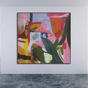 May include: Abstract painting with bold colors and shapes. The painting features a pink background with red, yellow, green, and blue accents. The painting is framed in a black frame.