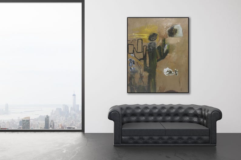 Puede incluir: Pintura abstracta con colores marrones, amarillos y verdes. La pintura presenta una gran forma abstracta en el centro, rodeada de formas y l&iacute;neas m&aacute;s peque&ntilde;as. La pintura est&aacute; enmarcada en un marco negro y cuelga de una pared blanca.