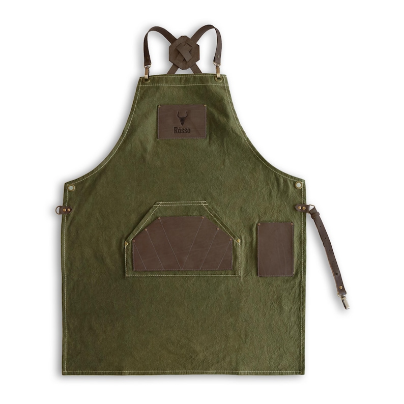 May include: Green canvas apron with brown leather straps, a large pocket, and a smaller pocket on the right side. The apron has a brown leather patch with the word "Rosso" and a bull's head logo.