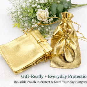 a set of gold-colored fabric bags, some of which appear to be gift-ready and others that seem to be everyday protection bags. The bags are placed next to a bouquet of white flowers, creating a visually appealing and elegant display.
