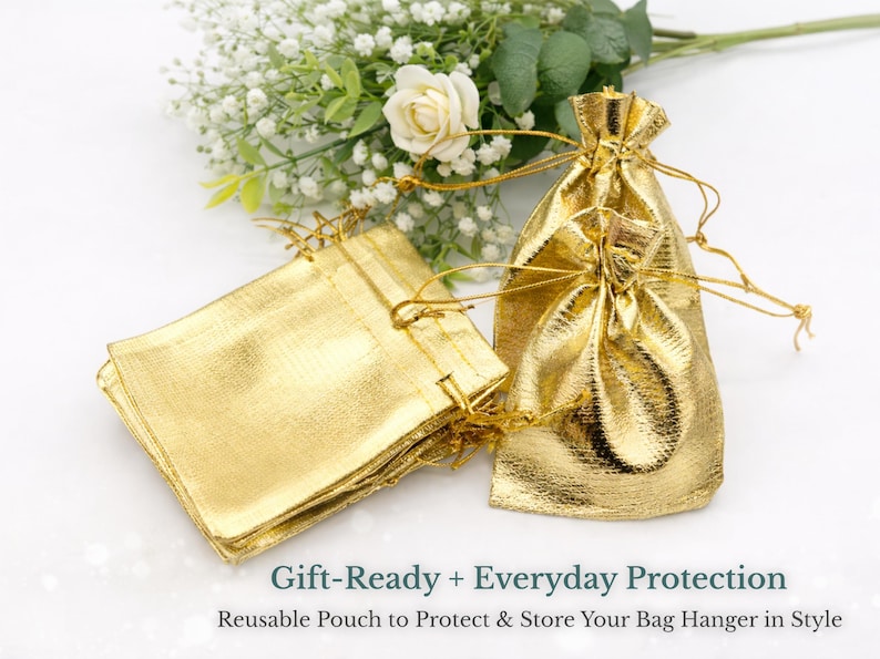 a set of gold-colored fabric bags, some of which appear to be gift-ready and others that seem to be everyday protection bags. The bags are placed next to a bouquet of white flowers, creating a visually appealing and elegant display.