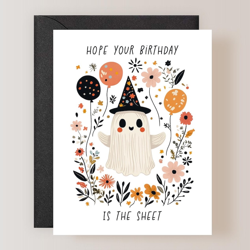 May include: A white ghost wearing a witch hat with colorful stars and a black and white polka dot balloon, surrounded by colorful flowers and the text "Hope your birthday is the sheet".