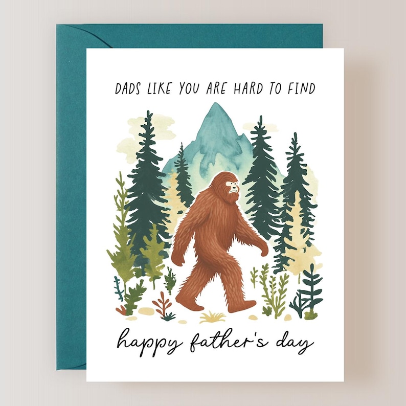 May include: A Father's Day card with a cartoon Bigfoot walking through a forest. The card reads "Dads like you are hard to find. Happy Father's Day."