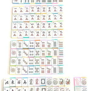 May include: A collection of colorful Mahjong tiles, featuring various symbols and numbers. The tiles are arranged in multiple stacks, showcasing the different suits and characters used in the game. The image includes tiles with the text "JOKER".