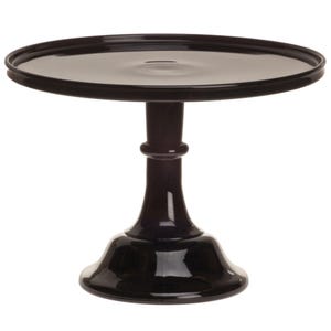 May include: A black, glossy cake stand with a round top and a pedestal base. The stand is made of a shiny material and is suitable for displaying desserts or other items. The stand's height is approximately 8 inches.