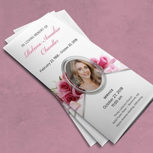 May include: A white funeral program with a photo of a woman in a silver frame surrounded by pink roses. The text reads "In loving memory of Rebecca Annalise Chandler, February 23, 1968 - October 20, 2018". The program also includes service details for October 27, 2018 at 11:00 am at Trinity Lutheran Church, 5432 Foster Road, Savannah, GA. Pastor Andrew Keating will officiate.