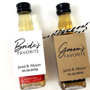 May include: Two miniature liquor bottles with personalized labels. The label on the left bottle reads "Bride's Favorite" with the names "Jared & Allyson" and the date "10.19.2019". The label on the right bottle reads "Groom's Favorite" with the same names and date.
