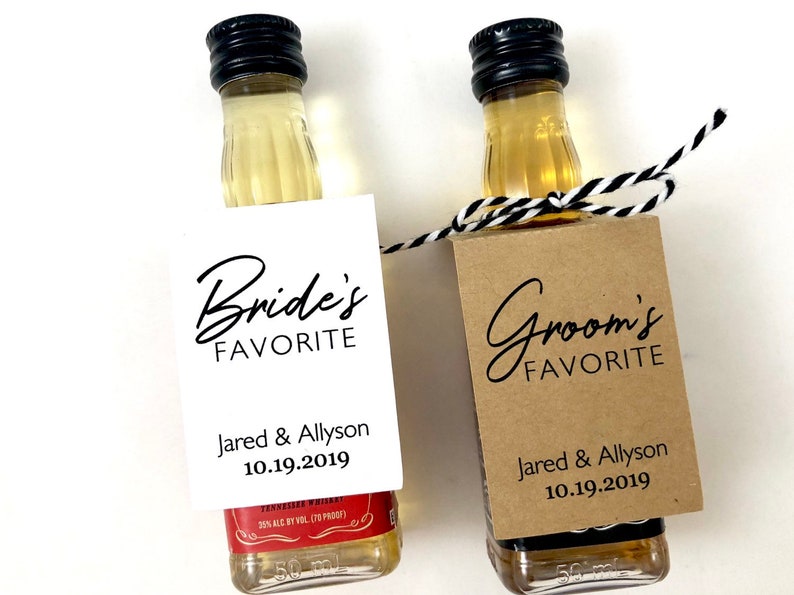 May include: Two miniature liquor bottles with personalized labels. The label on the left bottle reads "Bride's Favorite" with the names "Jared & Allyson" and the date "10.19.2019". The label on the right bottle reads "Groom's Favorite" with the same names and date.