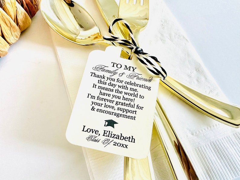May include: White card with black text that reads "To My Family & Friends Thank you for celebrating this day with me. It means the world to have you here! I'm forever grateful for your love, support & encouragement Love, Elizabeth Class of 20xx" with a black graduation cap icon.