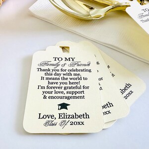 May include: White graduation favor tags with black text that reads "To My Family & Friends Thank you for celebrating this day with me. It means the world to have you here! I'm forever grateful for your love, support & encouragement Love, Elizabeth Class of 20XX".