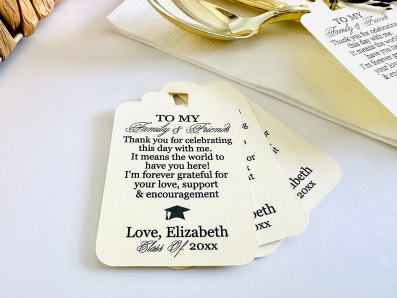 May include: White graduation favor tags with black text that reads "To My Family & Friends Thank you for celebrating this day with me. It means the world to have you here! I'm forever grateful for your love, support & encouragement Love, Elizabeth Class of 20XX".