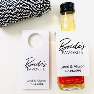 May include: White card stock bottle tag with the text "Bride's Favorite" and the names "Jared & Allyson" and the date "10.19.2019".