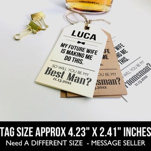 May include: Two white and brown gift tags with black text. The text on the white tag reads "LUCA MY FUTURE WIFE IS MAKING ME DO THIS. SO WILL YOU BE MY BEST MAN? 11.13.20XX". The text on the brown tag reads "WILL YOU BE MY GROOMSMAN? 11.13.20XX". The tags are approximately 4.23 inches by 2.41 inches.