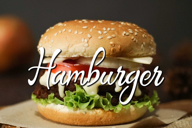May include: A hamburger with a sesame seed bun, lettuce, tomato, onion, cheese, and a creamy sauce. The word "Hamburger" is written in a cursive font across the image.