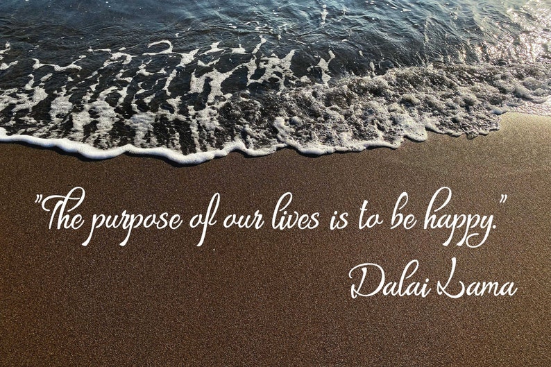 May include: A photograph of a beach with waves and sand. The quote "The purpose of our lives is to be happy." is written in white script, with "Dalai Lama" below it.