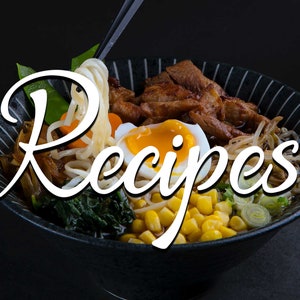 May include: A bowl of ramen with noodles, meat, corn, and a soft-boiled egg. The word "Recipes" is written in white cursive over the image. The bowl is black with white stripes.