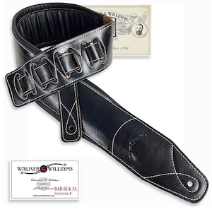 May include: Black leather guitar strap with white stitching and a buckle closure. The strap has a padded section and the text "Walker & Williams Signature 4" is printed on a white tag.