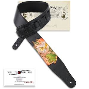 May include: Black leather guitar strap with an owl design. The strap has a brown, orange, and yellow owl with green leaves. The strap is adjustable and has a buckle. The strap is made by Walker & Williams.