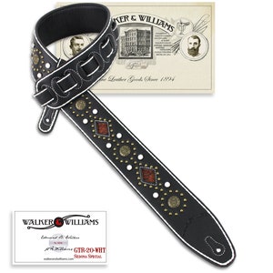 May include: Black leather guitar strap with white stitching, gold studs, and red and brown diamond-shaped inlays. The strap is decorated with the text "GTR-20-WHT SEDONA SPECIAL".