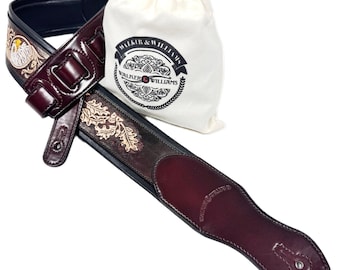 Correa de guitarra Walker and Williams KB-03-BRN de cuero marrón nogal oscuro con acolchado, diseño de águila americana y hojas de roble, para todo tipo de guitarras y bajos.