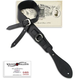 May include: Black leather guitar strap with a silver buckle and a large silver ring. The strap is labeled "G-815 SLATE BLACK" and "WALKER & WILLIAMS".