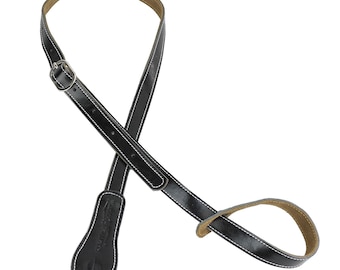 May include: Black leather guitar strap with white stitching and a silver buckle. The strap has a small loop on one end and a wider end with a logo.