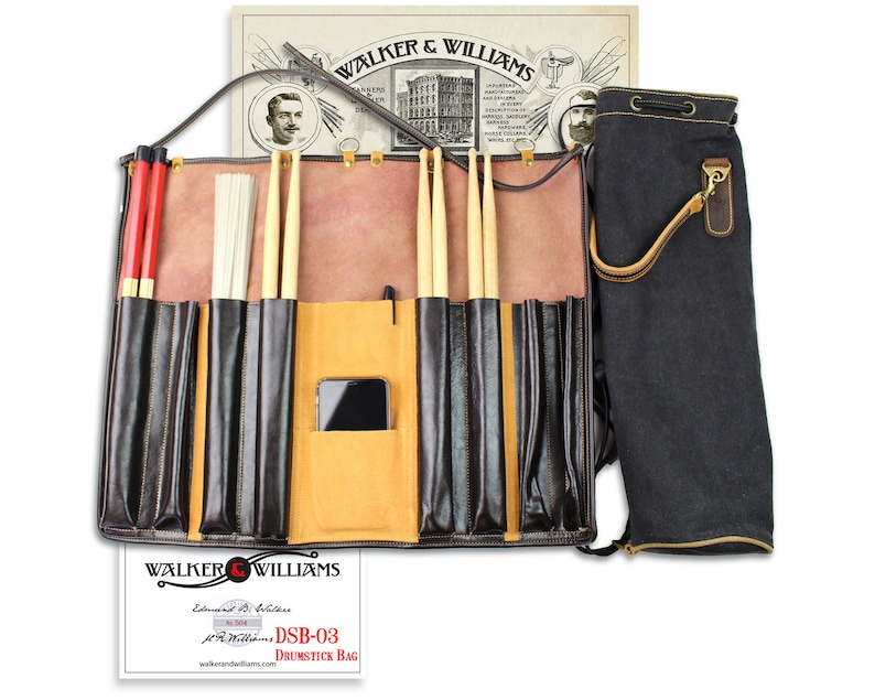 May include: A brown leather drumstick bag with multiple pockets for storing drumsticks, brushes, and other accessories. The bag has a black canvas carrying pouch attached to it. The bag is labeled "DSB-03 Drumstick Bag" and "Walker & Williams."