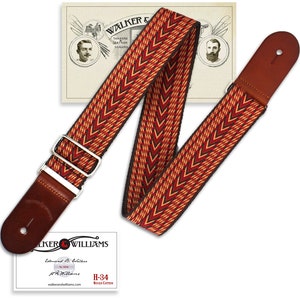 May include: A red, yellow, and black woven guitar strap with brown leather ends. The strap has a chevron pattern and is adjustable. The strap is labeled "H-34 Woven Cotton".
